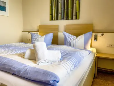 Ein Bett oder Betten in einem Zimmer der Unterkunft Haus Horizont I HZ21