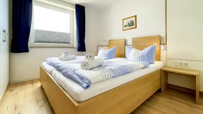 Ein Bett oder Betten in einem Zimmer der Unterkunft Haus Horizont I HZ04
