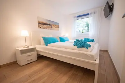 Ein Bett oder Betten in einem Zimmer der Unterkunft Haus Kirsten Duhnen FeWo 1