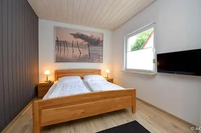 Ein Bett oder Betten in einem Zimmer der Unterkunft Strandkorb 12 - FeWo 1