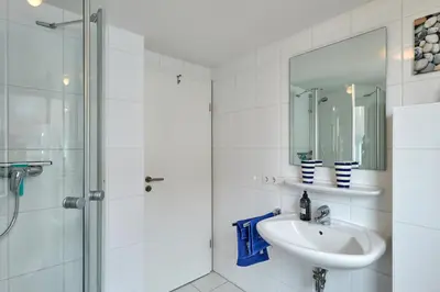 Ein Badezimmer in der Unterkunft Dünenweg 19, HD6