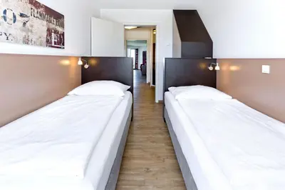 Ein Bett oder Betten in einem Zimmer der Unterkunft Residenz am Yachthafen, RY16