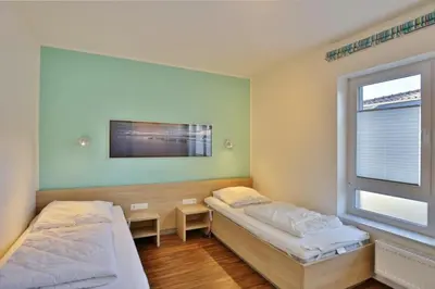 Ein Bett oder Betten in einem Zimmer der Unterkunft Wattwagen, RW3