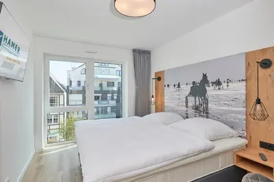 Ein Bett oder Betten in einem Zimmer der Unterkunft Nordstrand, N303