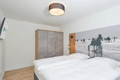 Ein Bett oder Betten in einem Zimmer der Unterkunft Nordstrand, N204