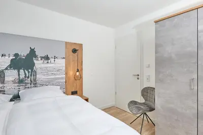 Ein Bett oder Betten in einem Zimmer der Unterkunft Nordstrand, N103