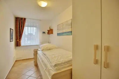 Ein Bett oder Betten in einem Zimmer der Unterkunft Duhner Brise, DB7