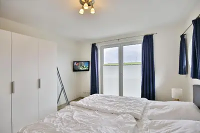 Ein Bett oder Betten in einem Zimmer der Unterkunft Nordseeblick, NB10