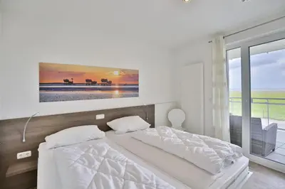 Ein Bett oder Betten in einem Zimmer der Unterkunft Dünenweg 37, DW2