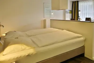 Ein Bett oder Betten in einem Zimmer der Unterkunft Duhner Strandhus, S206