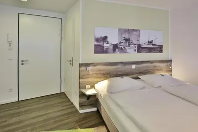 Ein Bett oder Betten in einem Zimmer der Unterkunft Duhner Strandhus, S206