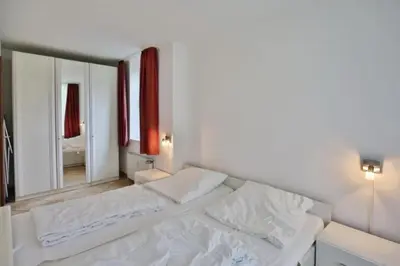 Ein Bett oder Betten in einem Zimmer der Unterkunft Hohe Worth, H1