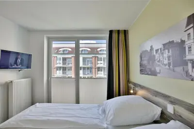 Ein Bett oder Betten in einem Zimmer der Unterkunft Duhner Strandhus, S208