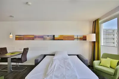 Ein Bett oder Betten in einem Zimmer der Unterkunft Duhner Strandhus, S208
