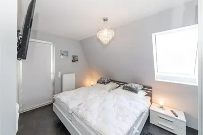 Ein Bett oder Betten in einem Zimmer der Unterkunft Dünenweg 37, DW5