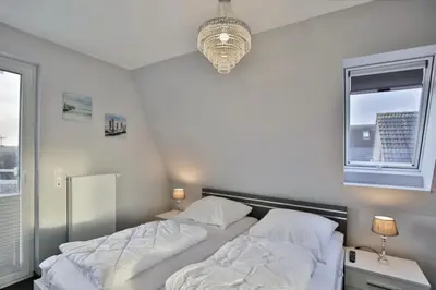Ein Bett oder Betten in einem Zimmer der Unterkunft Dünenweg 37, DW5