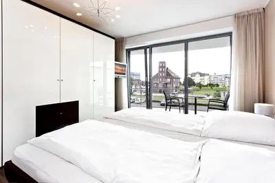 Ein Bett oder Betten in einem Zimmer der Unterkunft Residenz am Yachthafen, RY10