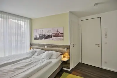 Ein Bett oder Betten in einem Zimmer der Unterkunft Duhner Strandhus, S2
