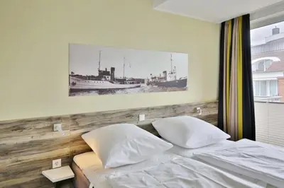 Ein Bett oder Betten in einem Zimmer der Unterkunft Duhner Strandhus, S304