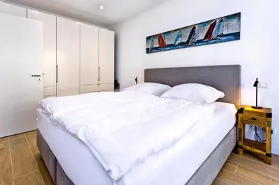 Ein Bett oder Betten in einem Zimmer der Unterkunft Duhner Spitze, DS18
