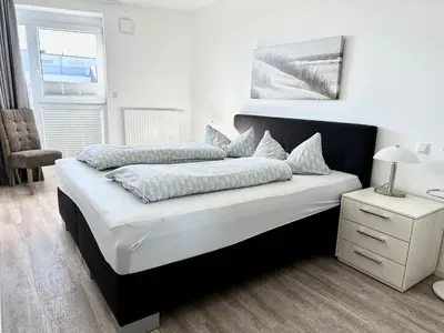 Ein Bett oder Betten in einem Zimmer der Unterkunft Ferienwohnung De Eller
