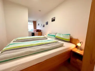 Ein Bett oder Betten in einem Zimmer der Unterkunft Ferienwohnung De Lachmööv