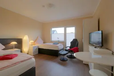 Ein Bett oder Betten in einem Zimmer der Unterkunft Gästehaus Dorum 03
