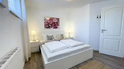 Ein Bett oder Betten in einem Zimmer der Unterkunft Kapitänshaus FeWo 7