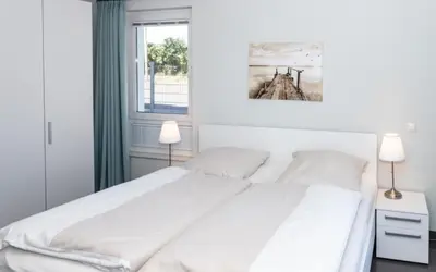 Ein Bett oder Betten in einem Zimmer der Unterkunft Düne 1 FeWo4 - Duene4u