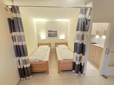 Ein Bett oder Betten in einem Zimmer der Unterkunft Strandhochhaus E3
