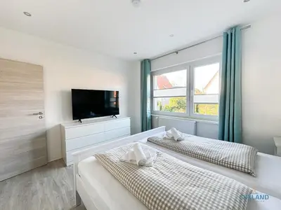 Ein Bett oder Betten in einem Zimmer der Unterkunft Ferienwohnung am Kurpark