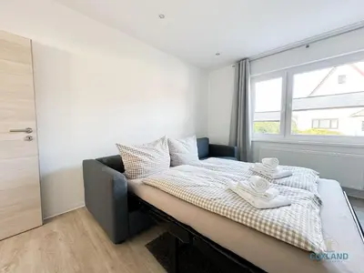Ein Bett oder Betten in einem Zimmer der Unterkunft Ferienwohnung am Kurpark