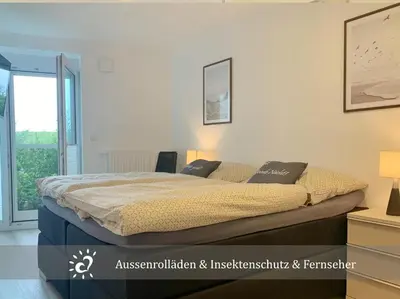 Ein Bett oder Betten in einem Zimmer der Unterkunft De Wittling Nordseeglück direkt am Deich &Hund willkommen