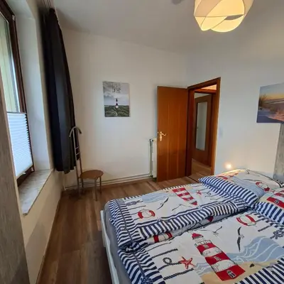 Ein Bett oder Betten in einem Zimmer der Unterkunft Ferienwohnung Büsum Zentrum - Einkaufsmeile und Meer