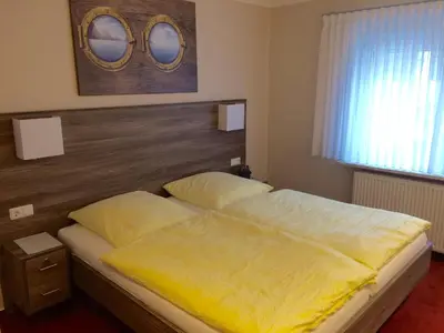 Ein Bett oder Betten in einem Zimmer der Unterkunft Gästehaus Janßen