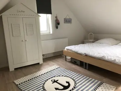 Ein Bett oder Betten in einem Zimmer der Unterkunft Ferienhaus Nordseejuwel