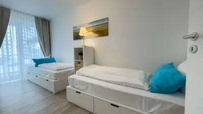 Ein Bett oder Betten in einem Zimmer der Unterkunft Strandhaus Nordseebrandung Fewo B1.1
