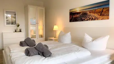 Ein Bett oder Betten in einem Zimmer der Unterkunft Strandhaus Nordseebrandung Fewo B3.2