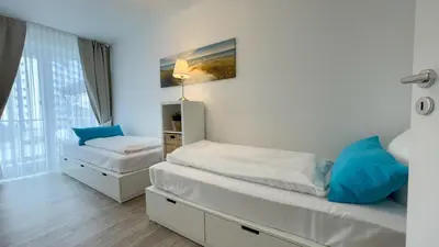 Ein Bett oder Betten in einem Zimmer der Unterkunft Strandhaus Nordseebrandung Fewo B3.1