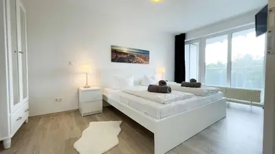 Ein Bett oder Betten in einem Zimmer der Unterkunft Strandhaus Nordseebrandung Fewo A2.2