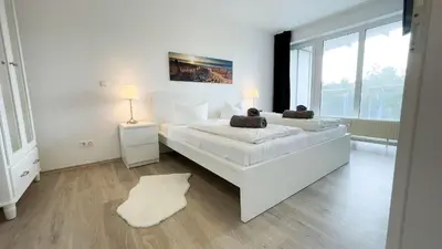 Ein Bett oder Betten in einem Zimmer der Unterkunft Strandhaus Nordseebrandung Fewo A1.2