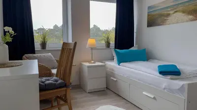 Ein Bett oder Betten in einem Zimmer der Unterkunft Strandhaus Nordseebrandung Fewo B2.3