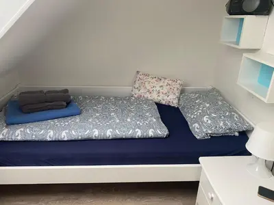 Ein Bett oder Betten in einem Zimmer der Unterkunft Ferienwohnung Möwenschiss - Haus Bake