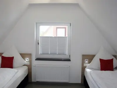 Ein Bett oder Betten in einem Zimmer der Unterkunft Ferienwohnung dat witte hus 2