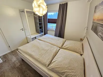 Ein Bett oder Betten in einem Zimmer der Unterkunft Appartementhaus Kogge Wohnung 11