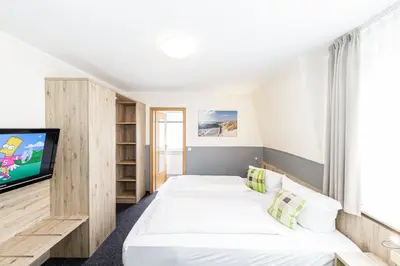 Ein Bett oder Betten in einem Zimmer der Unterkunft Gästehaus Alexandra