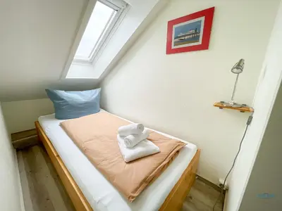 Ein Bett oder Betten in einem Zimmer der Unterkunft Urlaub mit Blick auf den Duhner Strand