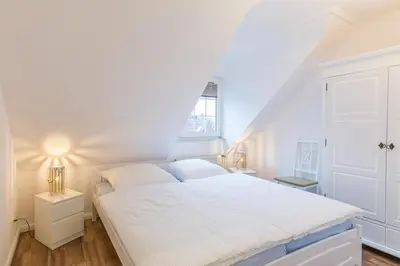Ein Bett oder Betten in einem Zimmer der Unterkunft Fischerhus - Wohnung 8