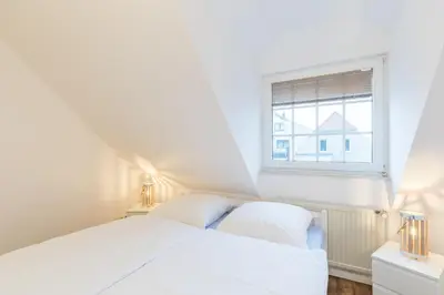 Ein Bett oder Betten in einem Zimmer der Unterkunft Fischerhus - Wohnung 8