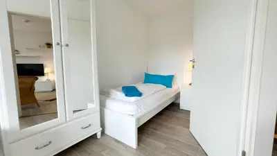 Ein Bett oder Betten in einem Zimmer der Unterkunft Ferienwohnung Nordseebrandung A3.3